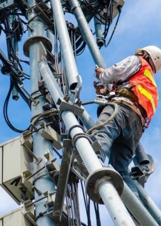Worker climbing an electric structure